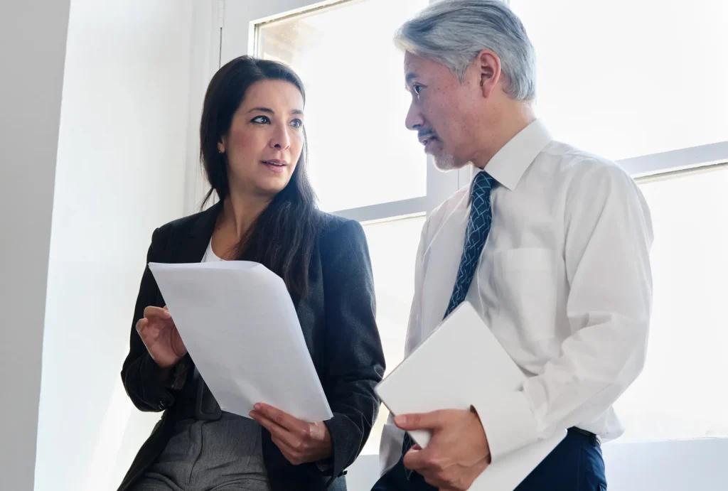 People looking at a checklist for finding cash flow