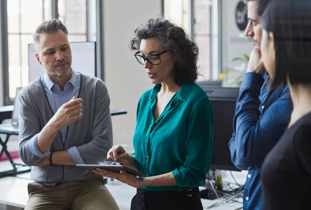 middle-aged man sitting with retirement plan advisors