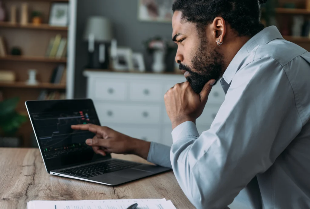 man looking at stocks on computer