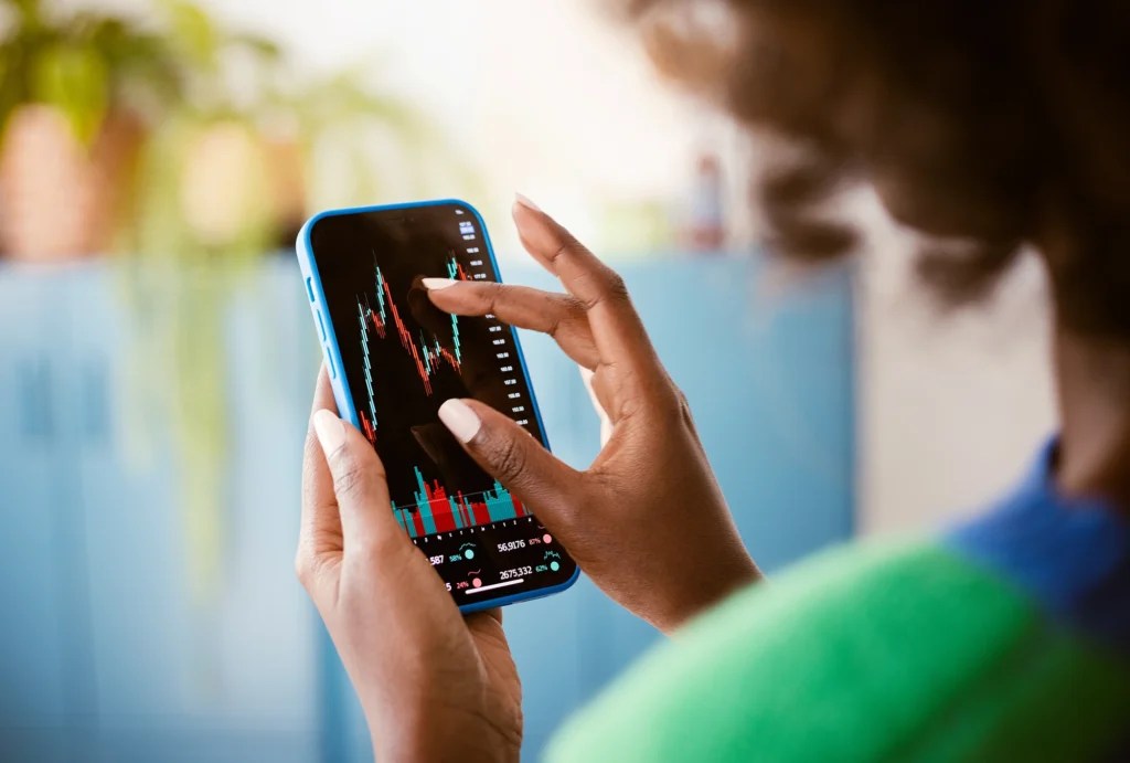 woman looking at stocks on her phone