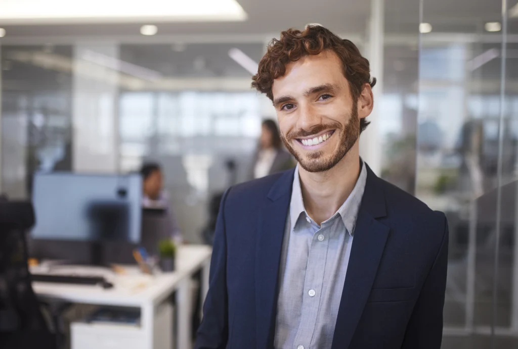 young business professional in office, smiling