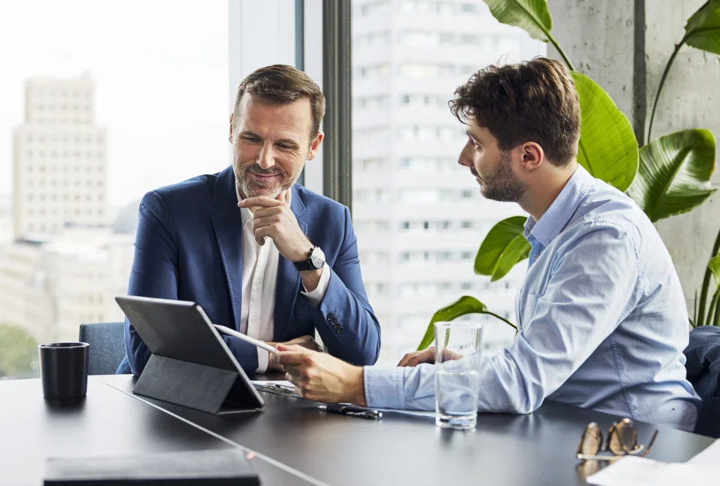 man sitting with foundation director discussing charitable giving options